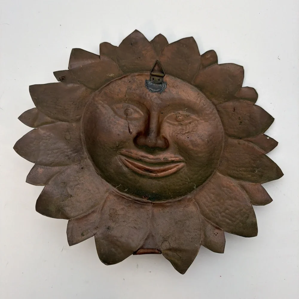 vintage sun wall plaque made of hammered copper sheet metal.